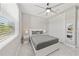 Bright bedroom features a large window, ceiling fan, closet, and neutral decor at 2186 Florala St, North Port, FL 34287