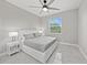 Cozy bedroom featuring a comfortable bed, a ceiling fan, and a bright window with natural light at 2186 Florala St, North Port, FL 34287