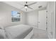 Bright bedroom with a large window, ceiling fan, and a full-length mirror at 2186 Florala St, North Port, FL 34287