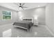 Neutral bedroom featuring a ceiling fan, a window with a view, and tile flooring at 2186 Florala St, North Port, FL 34287