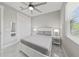 Comfortable bedroom featuring neutral décor, large window, ceiling fan, and closet at 2186 Florala St, North Port, FL 34287