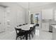 Elegant dining room with a modern light fixture, a large dining table, and access to the patio at 2186 Florala St, North Port, FL 34287