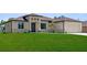Charming single-story home featuring a well-manicured lawn and attached two car garage at 2186 Florala St, North Port, FL 34287