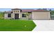 Beautiful single-story home featuring a well manicured lawn and a wide driveway leading to a two-car garage at 2186 Florala St, North Port, FL 34287