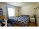 Bedroom with a patterned comforter, side table and closet space at 2275 S Mccall Rd # 103, Englewood, FL 34224