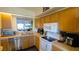 Bright kitchen with stainless steel dishwasher, light countertops and wood cabinets, offering functionality and style at 2275 S Mccall Rd # 103, Englewood, FL 34224
