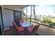 Relaxing lanai with table, chairs, and sunny views at 2275 S Mccall Rd # 103, Englewood, FL 34224