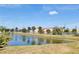 Scenic pond view with palm trees and lush landscaping, offering a tranquil setting near local businesses at 2275 S Mccall Rd # 103, Englewood, FL 34224