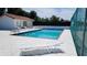 Inviting community pool with lounge chairs, adjacent to a building with a tile roof and well-maintained surroundings at 2275 S Mccall Rd # 103, Englewood, FL 34224