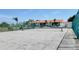 Well-maintained tennis court with a backdrop of community buildings and lush greenery at 2275 S Mccall Rd # 103, Englewood, FL 34224