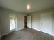 Spacious bedroom featuring tile floors, a glass sliding door, and white trim throughout at 23245 Jules Ave, Port Charlotte, FL 33980