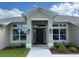 Inviting front entryway with decorative lighting and beautiful landscaping details at 23245 Jules Ave, Port Charlotte, FL 33980