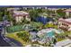 Elevated view of a waterfront condo community highlighting the pool, tennis court, and boat docks along the waterway at 25188 Marion Ave # 10, Punta Gorda, FL 33950