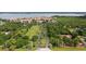 An aerial perspective captures a driveway leading to a neighborhood, surrounded by verdant trees and bushes at 25188 Marion Ave # 10, Punta Gorda, FL 33950