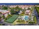 An aerial image captures a waterfront condo community with a pool, tennis court, boat docks, and serene waterways at 25188 Marion Ave # 10, Punta Gorda, FL 33950