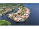 Aerial view of waterfront homes, private pools, and docks in a canal-front community at 25188 Marion Ave # 10, Punta Gorda, FL 33950