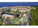 Waterfront condo community showcases tennis court, pool and nearby boat docks set against a blue water backdrop at 25188 Marion Ave # 10, Punta Gorda, FL 33950