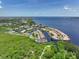 Aerial view showcases the layout of waterfront properties, boat docks, and surrounding landscape at 25188 Marion Ave # 10, Punta Gorda, FL 33950