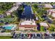 A picturesque aerial shot featuring a condo community with a pool, tennis court, parking, and waterway with boat docks at 25188 Marion Ave # 10, Punta Gorda, FL 33950