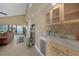 Living area with a beverage bar including wine storage and marble countertops at 25188 Marion Ave # 10, Punta Gorda, FL 33950