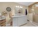 Well-lit bathroom with a spacious countertop, vanity mirror, and shower at 25188 Marion Ave # 10, Punta Gorda, FL 33950