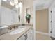 Bright bathroom featuring granite countertops, decorative lighting, and a large mirror at 25188 Marion Ave # 10, Punta Gorda, FL 33950