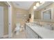 Bright bathroom featuring a white vanity with a marble countertop and decorative accents at 25188 Marion Ave # 10, Punta Gorda, FL 33950