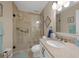 Bathroom featuring a glass-enclosed shower, neutral tile, and a granite vanity at 25188 Marion Ave # 10, Punta Gorda, FL 33950