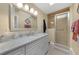 Well-lit bathroom featuring a vanity with a large mirror and a glass shower stall at 25188 Marion Ave # 10, Punta Gorda, FL 33950