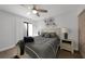 Bedroom featuring a decorative ceiling fan, grey and black bedding, and closet doors at 25188 Marion Ave # 10, Punta Gorda, FL 33950