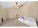 Bedroom featuring tile floors, ceiling fan and white twin beds with high ceilings at 25188 Marion Ave # 10, Punta Gorda, FL 33950