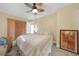 Bedroom featuring a queen bed, ceiling fan, and wood shutter doors at 25188 Marion Ave # 10, Punta Gorda, FL 33950