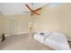 Bedroom featuring tile floors, ceiling fan and white twin beds with high ceilings at 25188 Marion Ave # 10, Punta Gorda, FL 33950