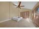 Bright bedroom with large window shutters, tile flooring, and a modern ceiling fan at 25188 Marion Ave # 10, Punta Gorda, FL 33950