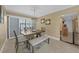 Well lit dining room with chair rail, beach artwork, modern chandelier, and bench seating at 25188 Marion Ave # 10, Punta Gorda, FL 33950