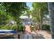 Picturesque view of a wooden dock leading to the waterfront, surrounded by lush greenery at 25188 Marion Ave # 10, Punta Gorda, FL 33950