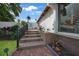 Charming backyard patio featuring brick pavers, wooden steps, and manicured landscaping at 25188 Marion Ave # 10, Punta Gorda, FL 33950