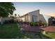 Charming home exterior with a brick path, lush landscaping, and a glimpse of the cozy front porch at 25188 Marion Ave # 10, Punta Gorda, FL 33950
