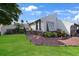 Charming home exterior with well-manicured lawn and inviting brick pathway at 25188 Marion Ave # 10, Punta Gorda, FL 33950