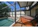 Relaxing screened patio with a hot tub, poolside access, and comfortable decking at 25188 Marion Ave # 10, Punta Gorda, FL 33950