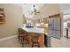 Modern kitchen featuring a large island, stainless steel fridge, and pendant lighting at 25188 Marion Ave # 10, Punta Gorda, FL 33950