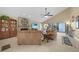 Bright living room boasts fireplace, ceiling fan, tile flooring, and comfortable seating at 25188 Marion Ave # 10, Punta Gorda, FL 33950
