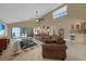 Bright, open living area with high ceilings, tile flooring, and access to lanai, perfect for entertaining at 25188 Marion Ave # 10, Punta Gorda, FL 33950