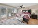 Bedroom with area rug, ceiling fan, and exit to pool area at 25188 Marion Ave # 10, Punta Gorda, FL 33950