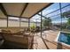 Inviting screened patio with comfortable seating, a grill, and views of the water and boats at 25188 Marion Ave # 10, Punta Gorda, FL 33950