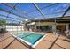 Gorgeous screened pool area with ample seating, a hot tub, and a spacious deck at 25188 Marion Ave # 10, Punta Gorda, FL 33950