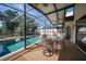 Backyard with enclosed pool, outdoor dining area, and landscaped surroundings at 25188 Marion Ave # 10, Punta Gorda, FL 33950