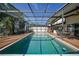 Beautiful pool area with a hot tub and outdoor furniture under a screened enclosure at 25188 Marion Ave # 10, Punta Gorda, FL 33950