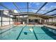 Pool area featuring a hot tub and seating, enclosed for privacy and shade at 25188 Marion Ave # 10, Punta Gorda, FL 33950