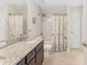 Bathroom with a granite vanity, shower-tub combo with decorative shower curtain, and tiled flooring, adding charm at 27147 Guapore Dr, Punta Gorda, FL 33983